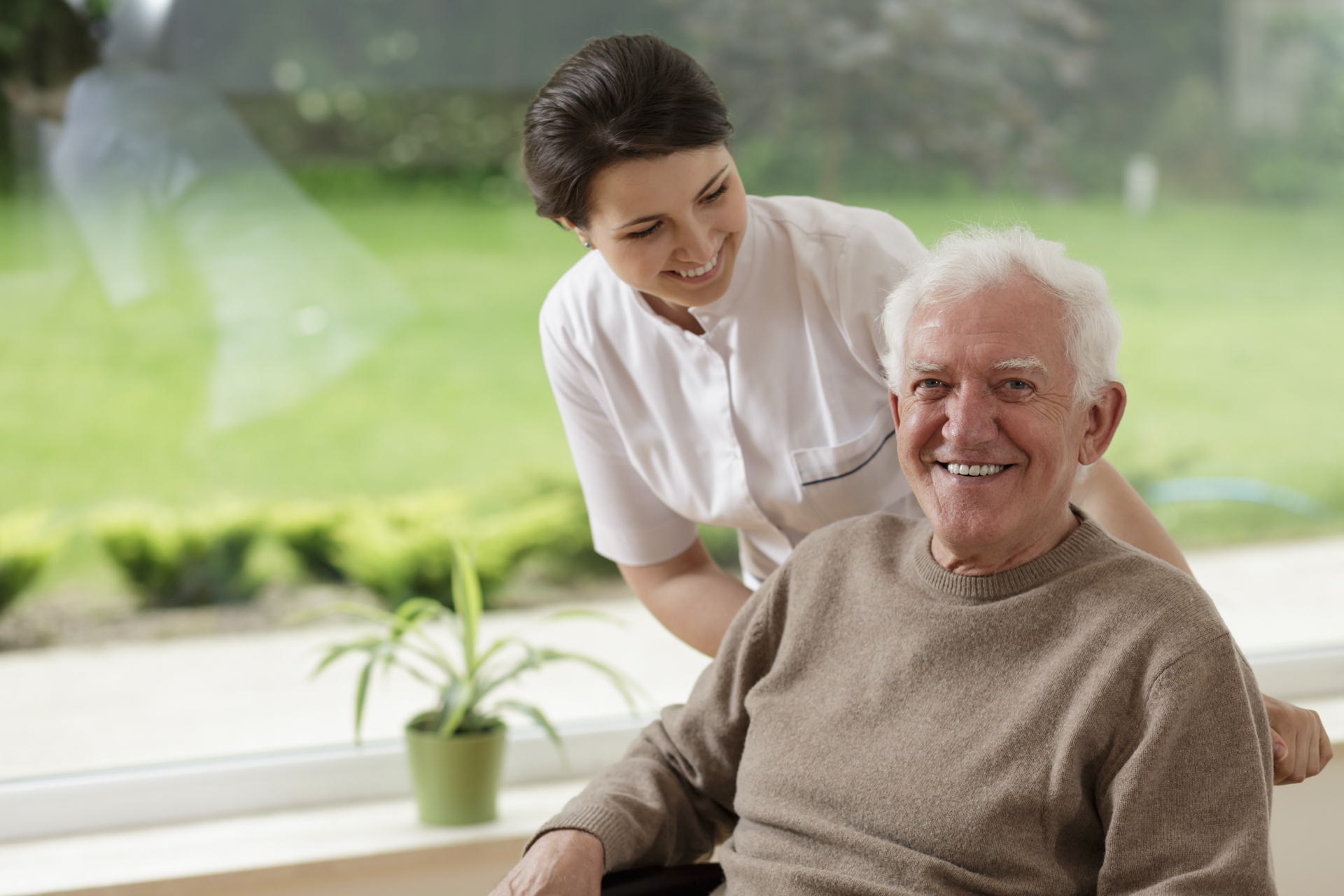 Caregiver pushing elder in wheelchair